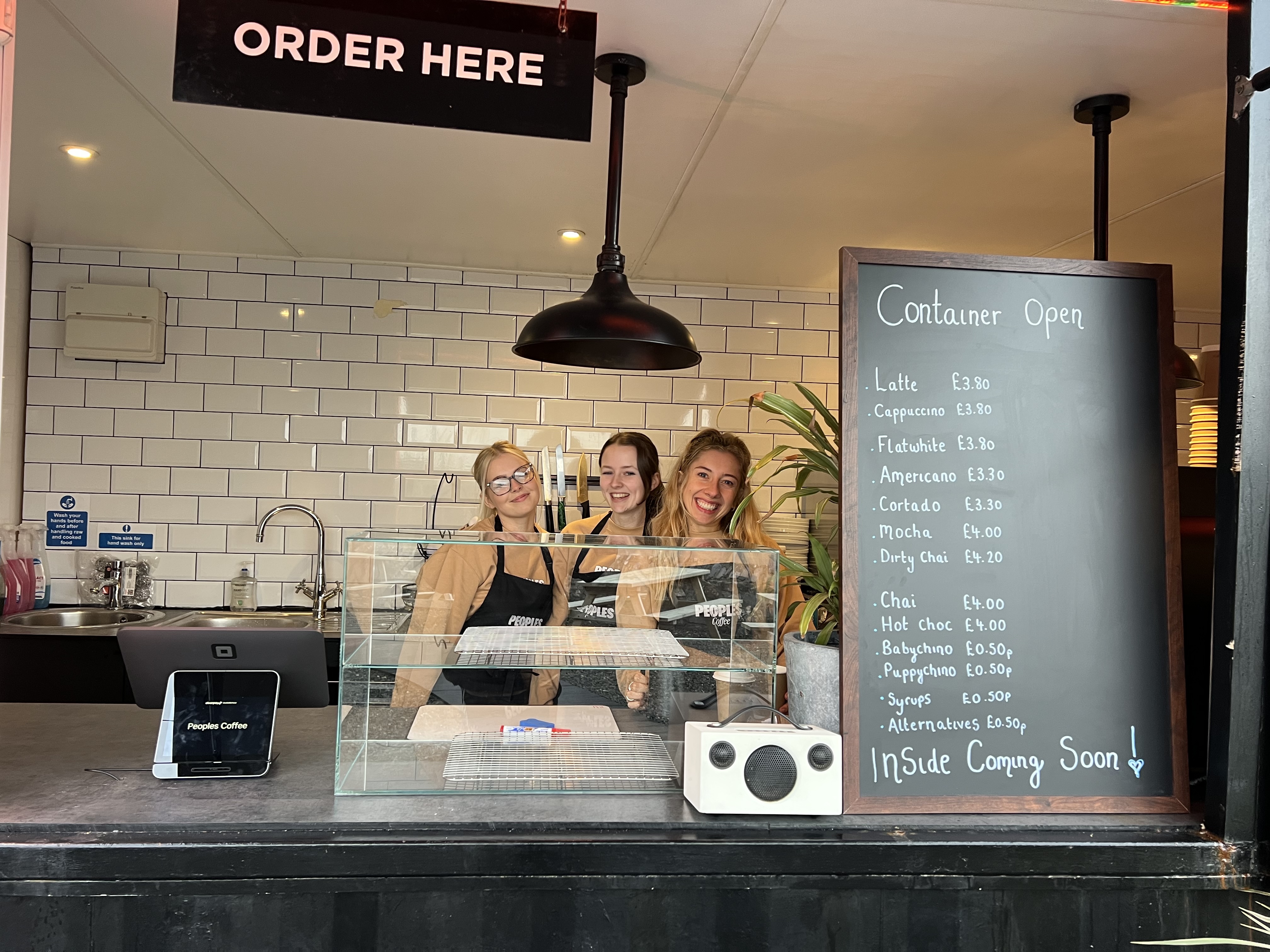 The Peoples Coffee container bar with the team serving at the hatch